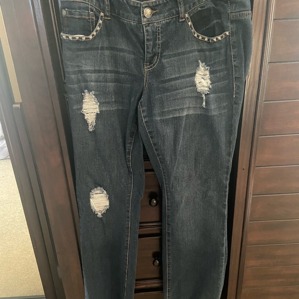 Torrid jeans distressed with silver pointed grommets on front and back pockets